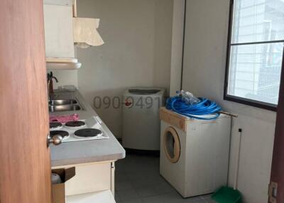 Compact kitchen with white cabinetry and appliances