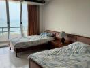 Spacious bedroom with twin beds and ocean view