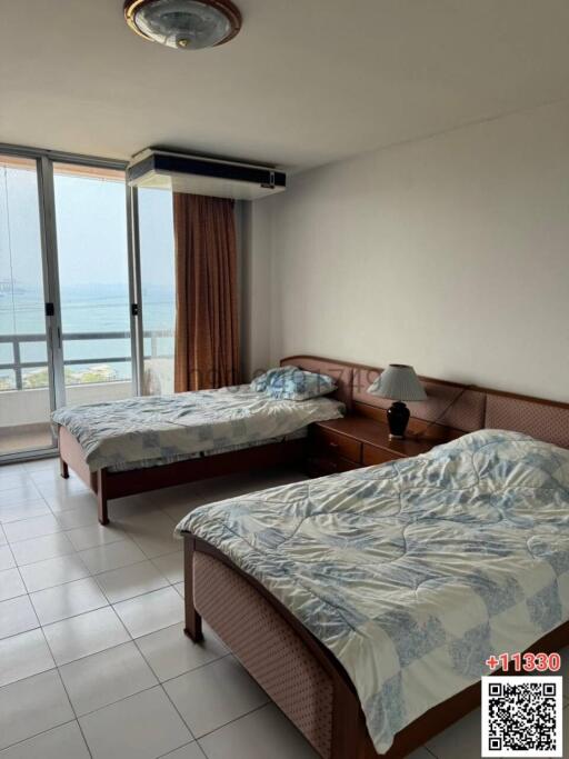 Spacious bedroom with twin beds and ocean view