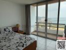 Spacious bedroom with large window offering sea view