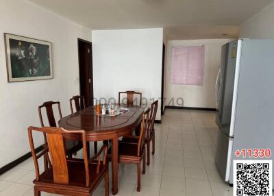 Spacious dining area with table set and large refrigerator