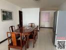 Spacious dining area with table set and large refrigerator