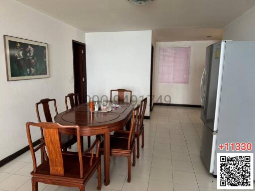 Spacious dining area with table set and large refrigerator
