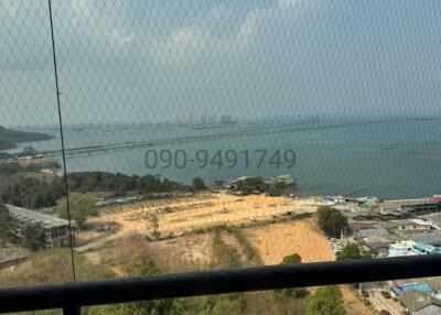 View from balcony overlooking sea and construction area