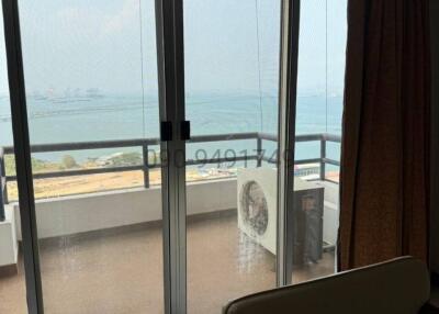 Coastal living room with ocean view and balcony access