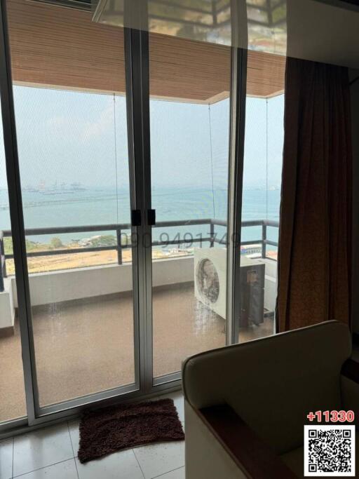 Coastal living room with ocean view and balcony access