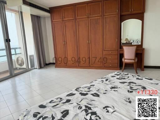 Spacious bedroom with large wardrobe and balcony access