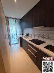 Modern kitchen with dark cabinetry and built-in appliances