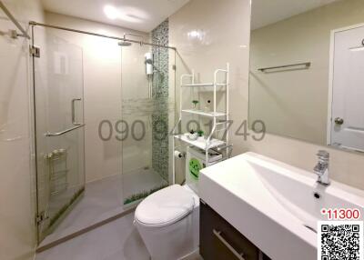 Modern bathroom with walk-in shower and white fixtures