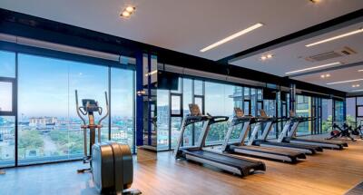 Modern gym with treadmills overlooking the city