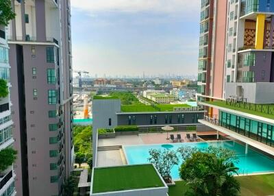 Stunning view from a high-rise building featuring amenities such as a swimming pool and landscaped gardens