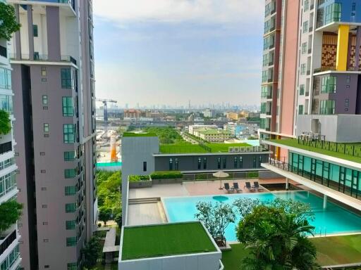 Stunning view from a high-rise building featuring amenities such as a swimming pool and landscaped gardens