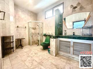 Spacious bathroom with natural light and modern amenities