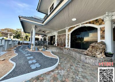 Exterior view of a house showing the entrance and patio area