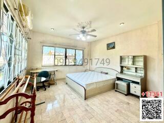 Spacious bedroom with natural light and tiled flooring