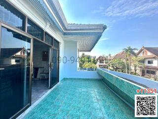 Spacious balcony with blue flooring and a clear sky view