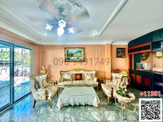 Spacious and brightly lit living room with elegant furniture and large windows