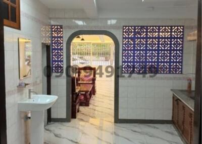 Modern bathroom with decorative tiles and natural lighting