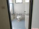 Compact tiled bathroom with toilet and window