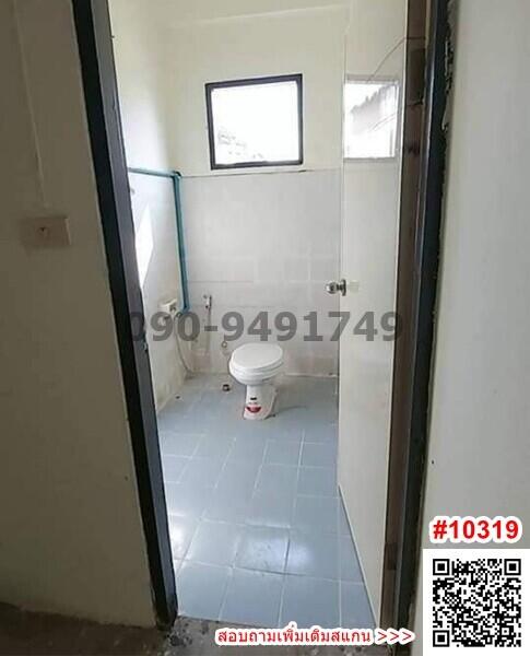 Compact tiled bathroom with toilet and window