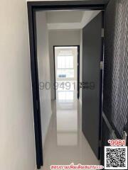 Bright corridor in modern home featuring clean design with a white tiled floor and neutral walls