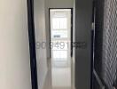 Bright corridor in modern home featuring clean design with a white tiled floor and neutral walls