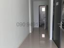 Bright and clean corridor leading to the rooms with tiled floor