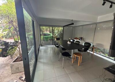 Spacious enclosed patio with dining area and garden view
