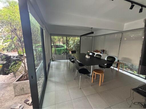 Spacious enclosed patio with dining area and garden view