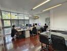 Spacious office environment with multiple workstations and natural light