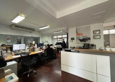Spacious commercial office space with desks and modern lighting