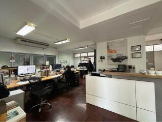 Spacious commercial office space with desks and modern lighting