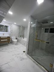 Modern bathroom with marble finish and glass shower