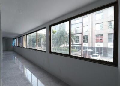 Bright hallway with large windows and reflective flooring in an urban building