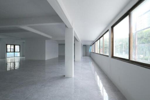 Spacious unfurnished interior of a modern building with large windows