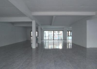 Spacious and well-lit empty interior of a building with reflective flooring