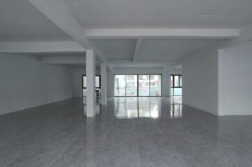 Spacious and well-lit empty interior of a building with reflective flooring