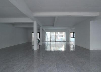 Spacious unfurnished interior of a modern building with large windows