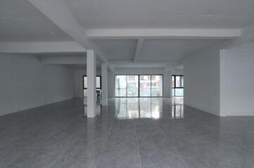 Spacious unfurnished interior of a modern building with large windows