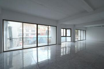 Spacious and well-lit empty interior of a building with large windows