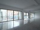 Spacious and well-lit empty interior of a building with large windows