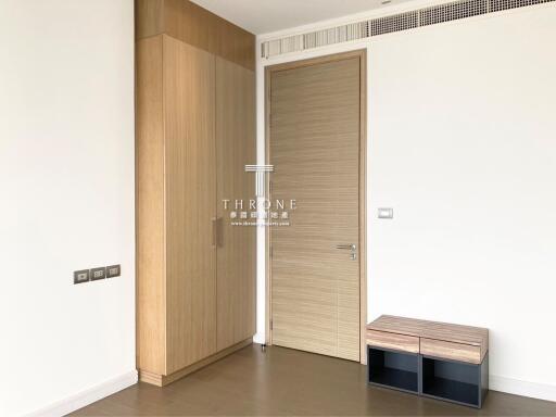 Modern bedroom entrance with wooden wardrobe and minimalist design