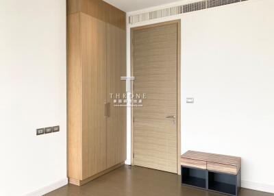 Modern bedroom entrance with wooden wardrobe and minimalist design