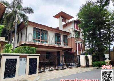 Spacious two-story residential home with large windows and a gated entrance