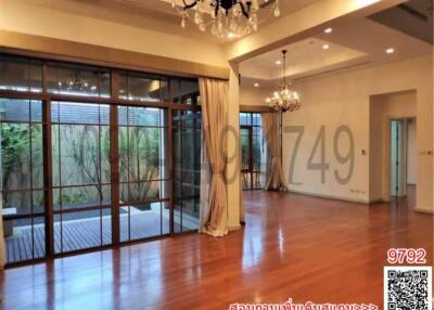 Spacious living room with hardwood floors and large windows