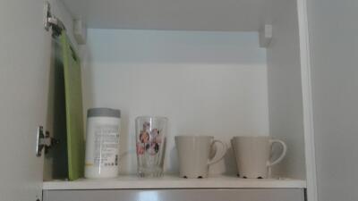 Kitchen cabinet with mugs and bottles