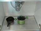 Under-sink kitchen cabinet with cooking pots