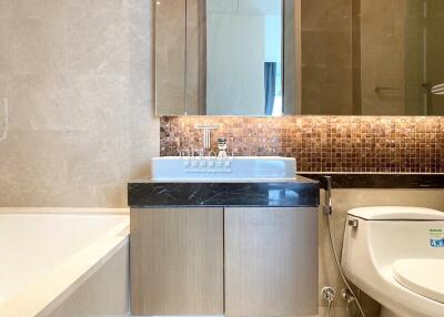 Modern bathroom interior with a mix of tile finishes and sleek fixtures