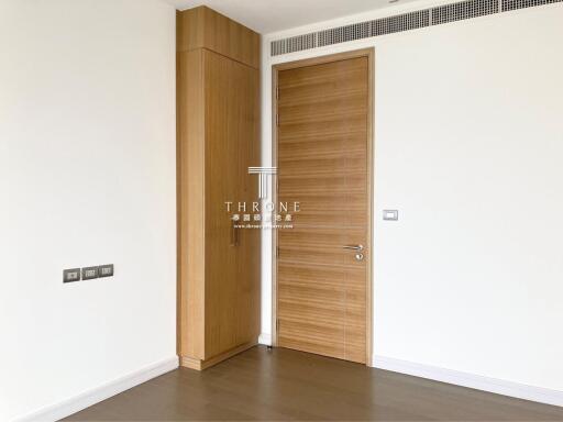 Modern interior design of a well-lit empty room with wooden doors