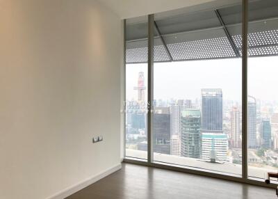 Modern living room with large windows featuring a city view